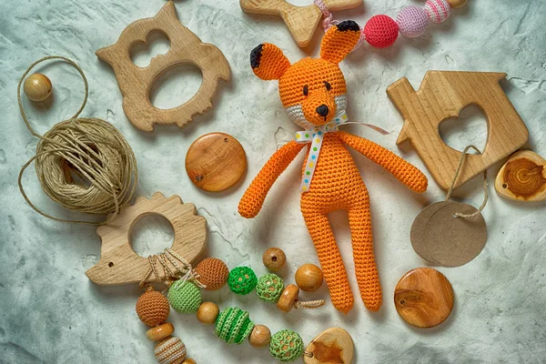 Heap of amigurumi fox and wooden toys — Stock Photo, Image