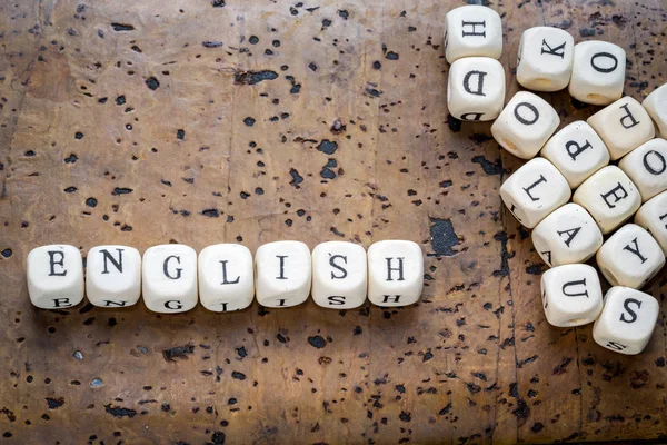 Ahşap blok blok yığını bir kahverengi mantar zemin üzerine yazılı İngilizce sözcük