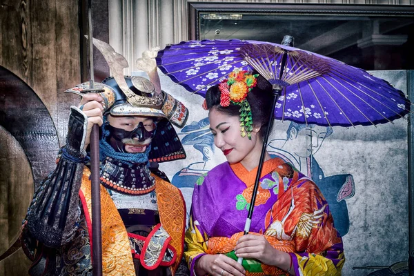 Moskva, Ryssland - 4 November, 2016: Iv stadsomfattande action festival "Night of the Arts". Samurai och geisha i tradition japanska dräkter välkomna gäster i Dk Nagorniy. — Stockfoto
