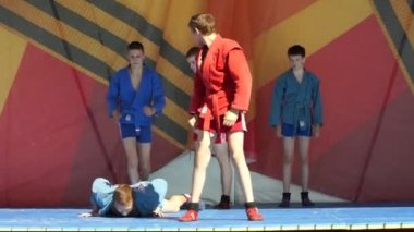 Moscow, Russia - May 14, 2017: russian sambo sportsmen perform kata and sparing fights during on the festival of martial arts `One in the field warrior`.