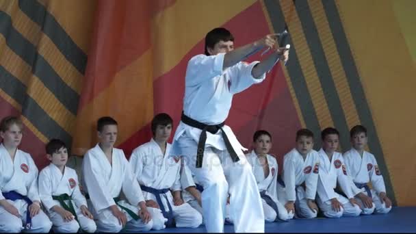 Moscow, Russia - May 14, 2017: karate man shows kata with two daggers on the festival of martial arts `One in the field is warrior`. — Stok Video