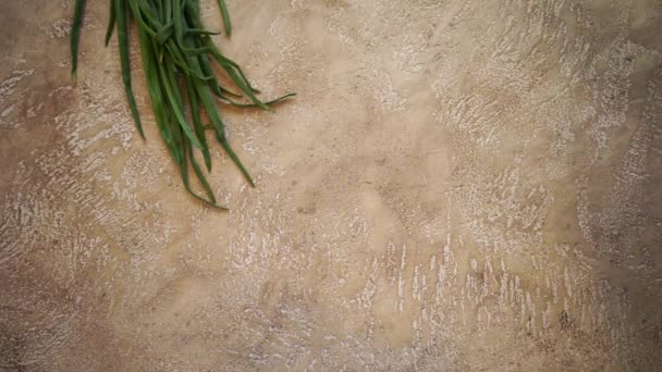 Making a frame from raw vegetables on a beige cement background with copy space for your text — Stock Video