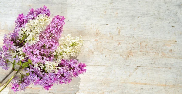 Ramo de flores de color lila blanco y violeta en una mesa de madera con espacio para copiar —  Fotos de Stock