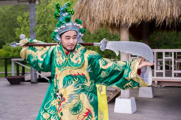 Chinese man in traditional costume with sword outdoor — Stock Photo, Image