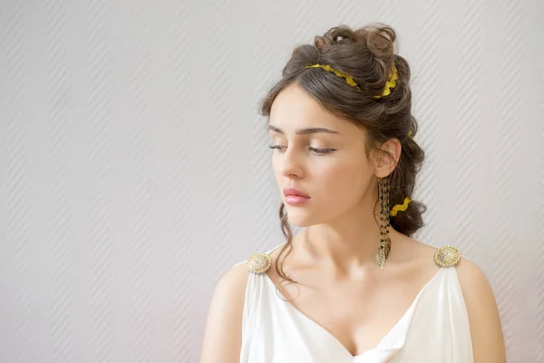 portrait of a graceful beautiful greece woman in traditional white tunic closed her eyes with copy space