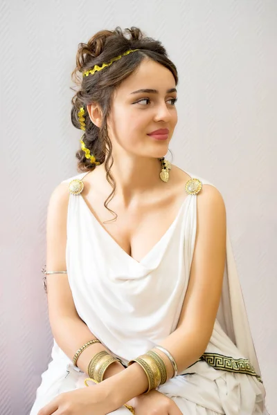 Portrait of charming young greek woman in antique white dress looking side — Stock Photo, Image