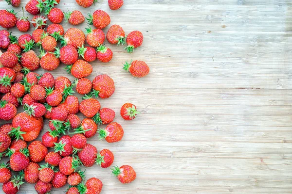 Strawberries on a wooden table, top view with a copy space — Stock Photo, Image