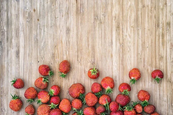 Strawberries on a wooden table, top view with copy space for your text — Stock Photo, Image