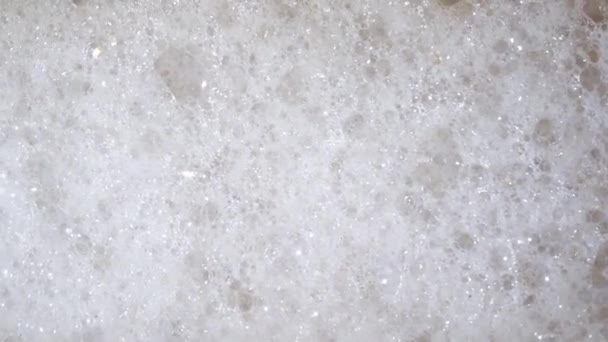 Vitt skum bubbles på tvättmaskinen, närbild ovanifrån för din bakgrund — Stockvideo