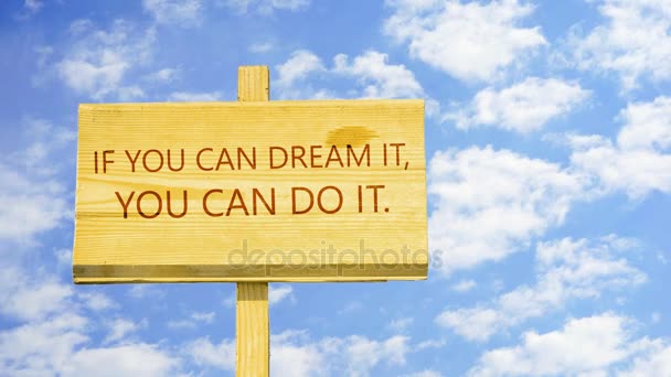 If you can dream it, you can do it. Motivational quote to create future. Words on a wooden sign against time lapse clouds in the blue sky. — Stock Video