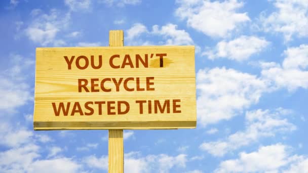 You can't recycle wasted time. Words on a wooden sign against time lapse clouds in the blue sky. — Stockvideo