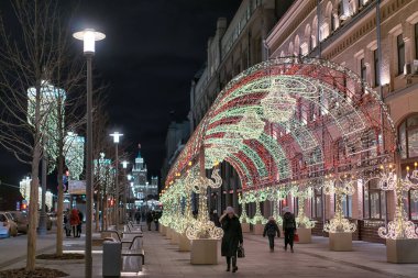 Moscow, Russia - December 21, 2019: Novaya square street with beautiful colorful Christmas decorations at the evening