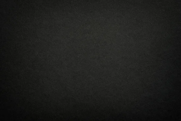 Black matte paper texture background. Surface of abstract dark texture. Gray blank page background flat close up view.