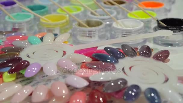 Many colored test samples of nail gel. — Stock Video