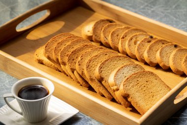 Nicely spread Rusks on a tray with Arabic coffee clipart