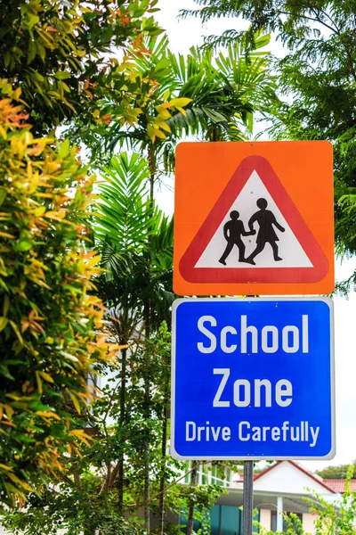 yellow color warning school zone traffic sign on road