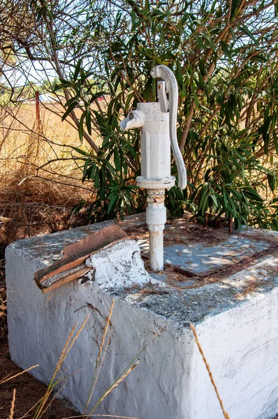 Pressure deep well hand pump. Old Hand water pump in the nature