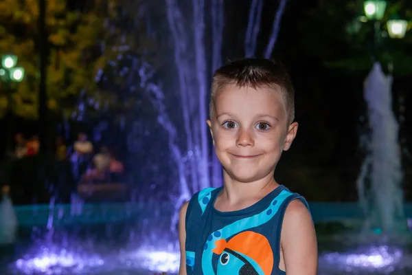 Handsome Boy Stands Colorful Fountain Night — Stock Photo, Image