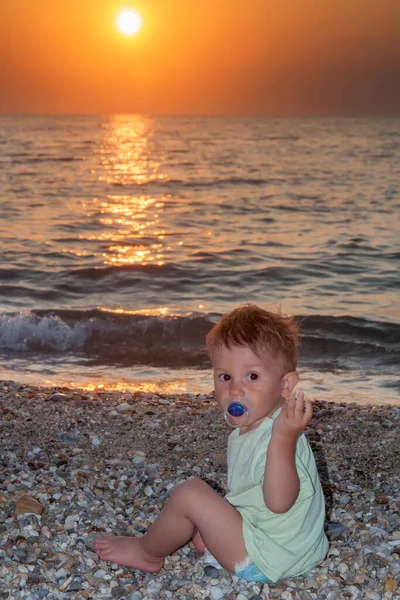 Niño Sentado Playa Con Chupete Puesta Sol — Foto de Stock