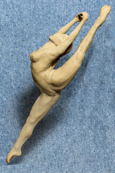 Gypsum sculpture of an unknown girl. The girl makes a gymnastic figure. Naked Girl Sculpture