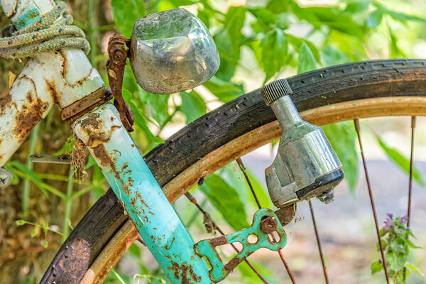 Old retro bicycle front macro view with dynamo, front wheel and headlight. Vintage concept, power generation tool, bicycle lighting equipment. 