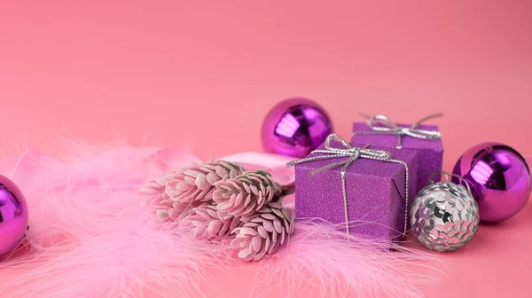 Pink festive Christmas background with fluffy feathers, a sprig — Stock Photo, Image