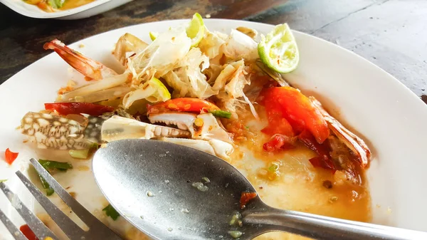 Empty dirty plate seafood paste on wooden table left after lunch — Stock Photo, Image