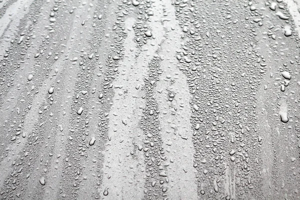 Woda kropla deszczu na maski samochodu — Zdjęcie stockowe