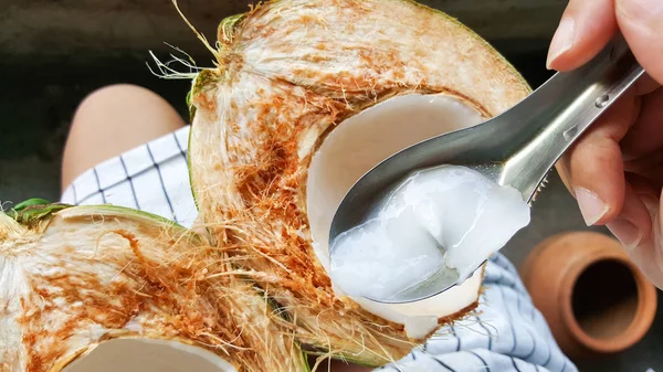 use spoon picking up young green coconuts with nutrient, health