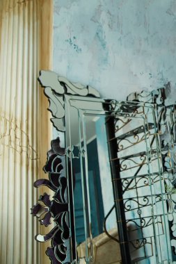 carved mirror on the background of the wall and columns