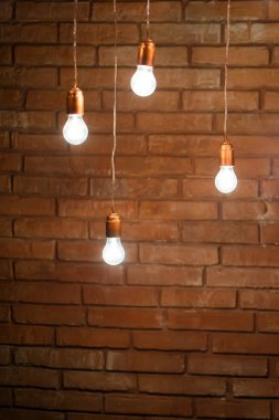 lamps with wires on a brick wall background