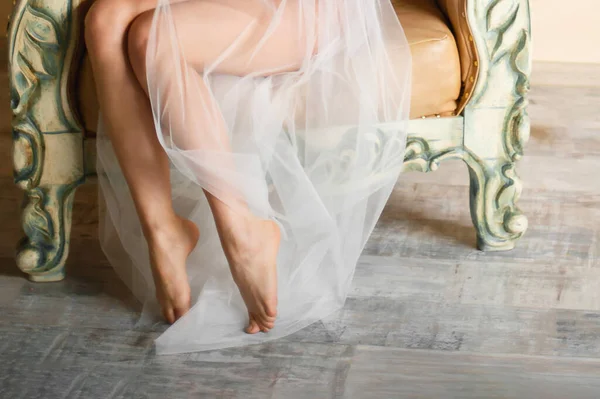 Jambes féminines dans une robe en mousseline de soie légère — Photo