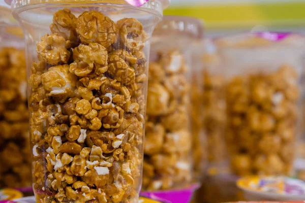 caramel popcorn, caramel popcorn in a jar on a shelf in the market