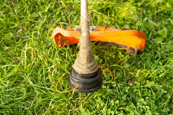 Close up of petrol trimmer on grass — Stock Photo, Image
