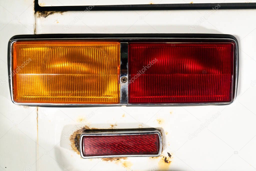 View from behind on a lantern or headlight of a car with a white body