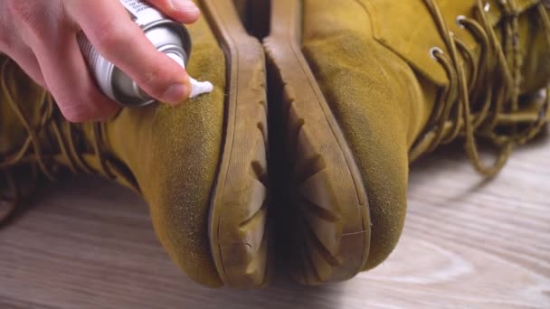 Крупным планом человек накладывает пену на грязные туфли с нубука — стоковое видео