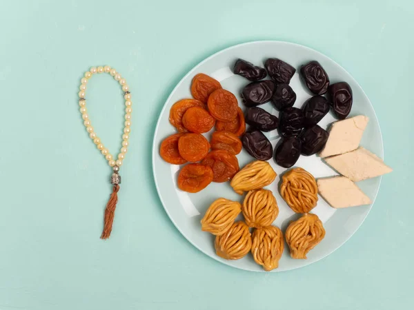 Flatley with rosaries, sweets, dates. The Concept Of Ramadan. Flat lay.