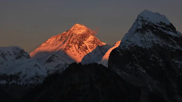 Illuminated peak of Mt Everest at sunset.