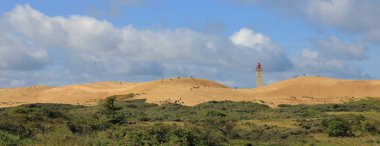 Uzak manzara Rubjerg Knude ve eski bir deniz feneri. Sahnede