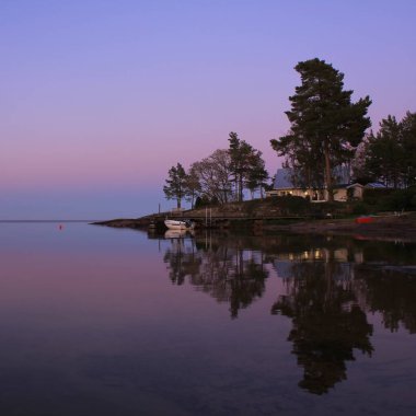 Calm evening at the shore of Lake Vanern, Sweden. clipart