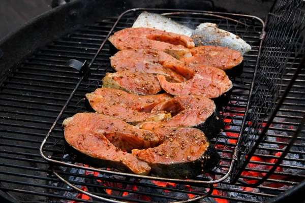 Salmon filet in teriyaki sauce on a barbeque grid. Red fish steaks in marinade over hot coals. Close-up of a grilled salmon steaks in barbeque grill. — Stock Image Salmon Filet Teriyaki Sauce Barbeque Grid Red Fish Steaks Marinade Stock Picture