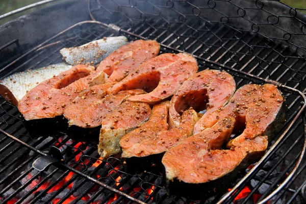 Salmon filet in teriyaki sauce on a barbeque grid. Red fish steaks in marinade over hot coals. Close-up of a grilled salmon steaks in barbeque grill. — Stock Image Salmon Filet Teriyaki Sauce Barbeque Grid Red Fish Steaks Marinade Royalty Free Stock Photos