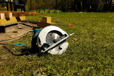 Elektrik kaynağına bağlı yuvarlak bir diskle dairesel testere. Kullanışlı dairesel testere.