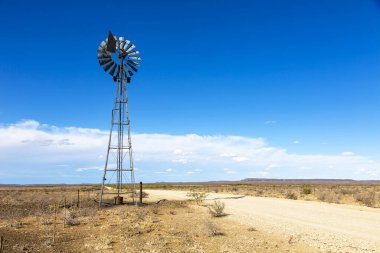 Rüzgâr pompası Karoo 'daki çakıl yolunun yanında.