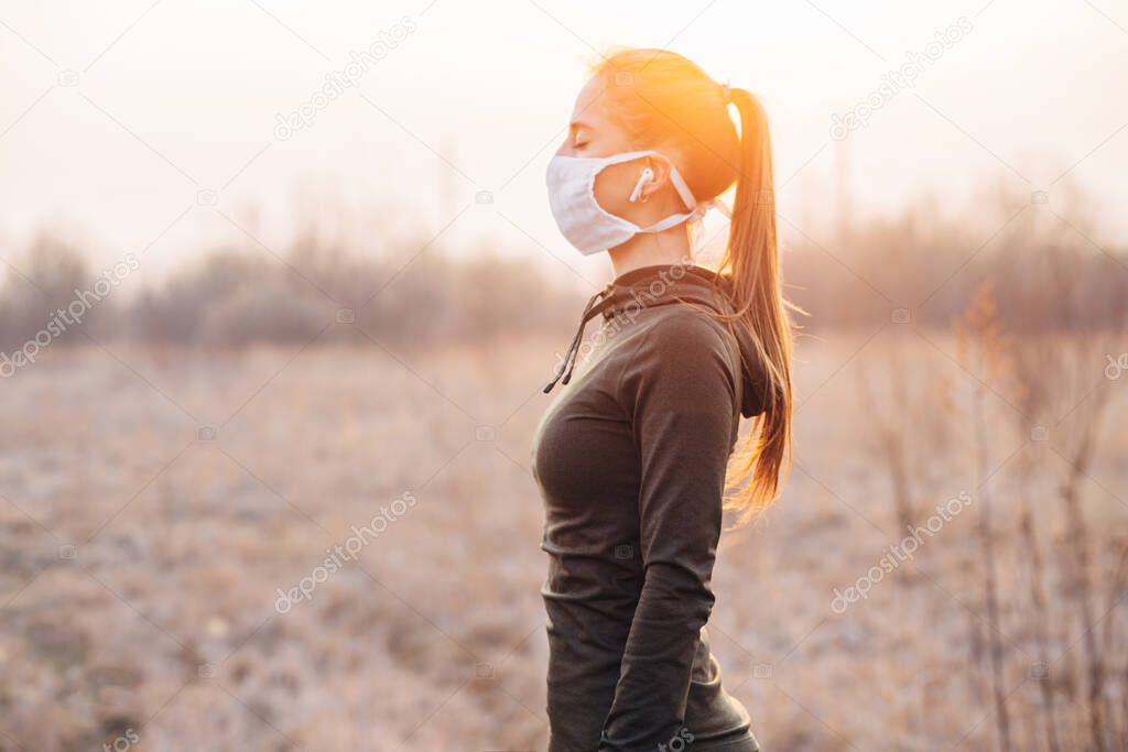 COVID-19 Pandemic Coronavirus girl in mask during quarantine went out to run