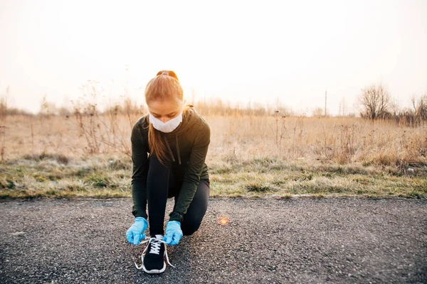 COVID-19 Pandemic Coronavirus girl in mask and blue gloves during quarantine went out to run