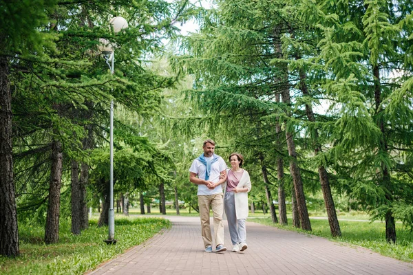 Ehepaar mittleren Alters spaziert im Park. — Stockfoto