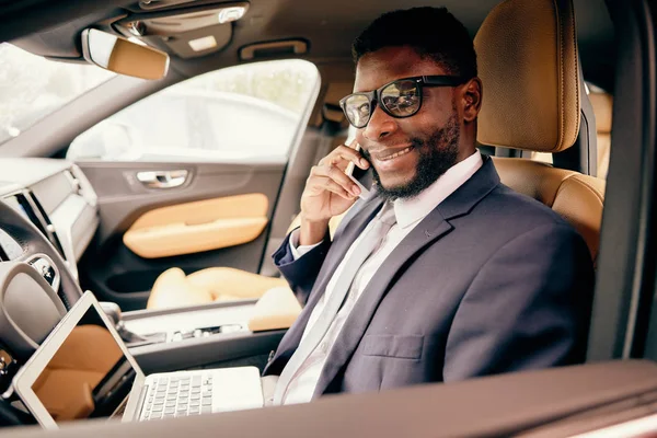 Üzletember dolgozik a laptop ül az autóban. — Stock Fotó