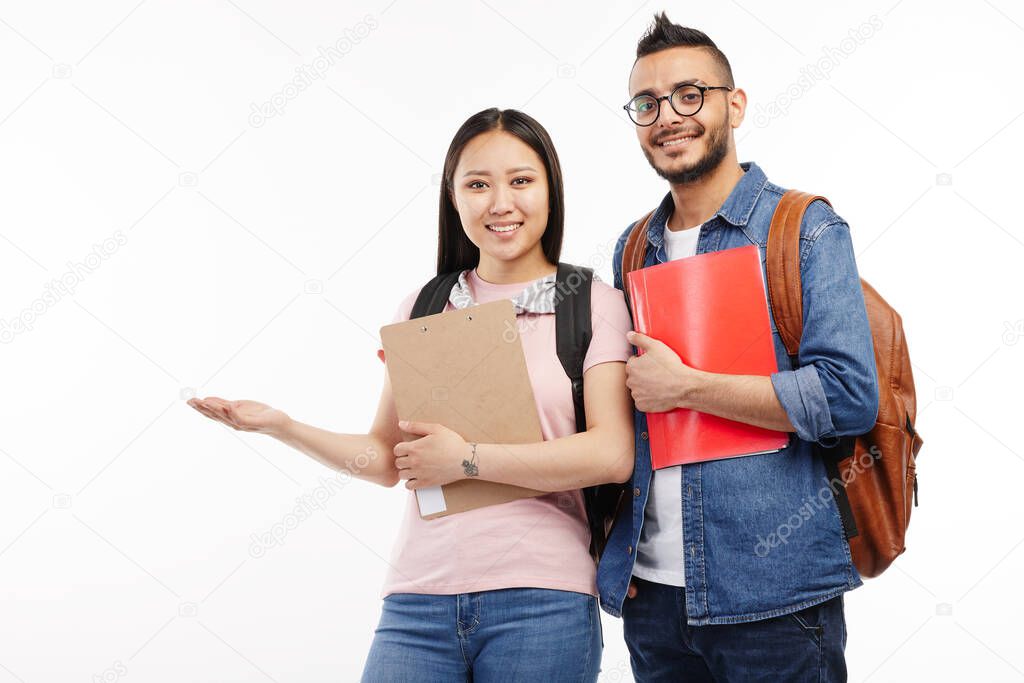 Two students pose together at the camera in various poses.