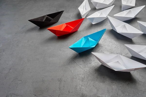 Business leadership Concept, Paper Boat, the key opinion Leader, the concept of influence.Business Concept, Paper Boat, the key opinion Leader, the concept of influence.Red,blue and black paper boat a